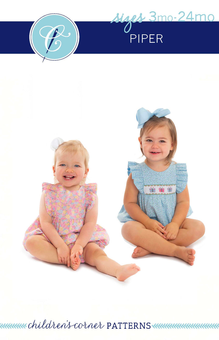 Two young children wearing dresses with a brand logo at the top.