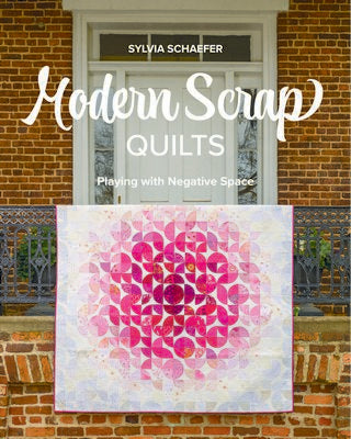 Book cover of 'Modern Scrap Quilts' by Sylvia Schaefer with a quilt displayed against a brick wall.
