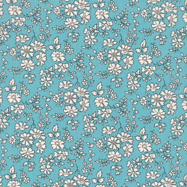 teal background with cream flowers and leaves