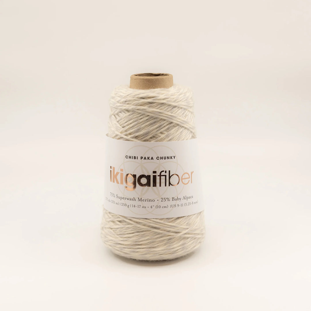 Spool of yarn with 'iki gaifiber' label on a white background