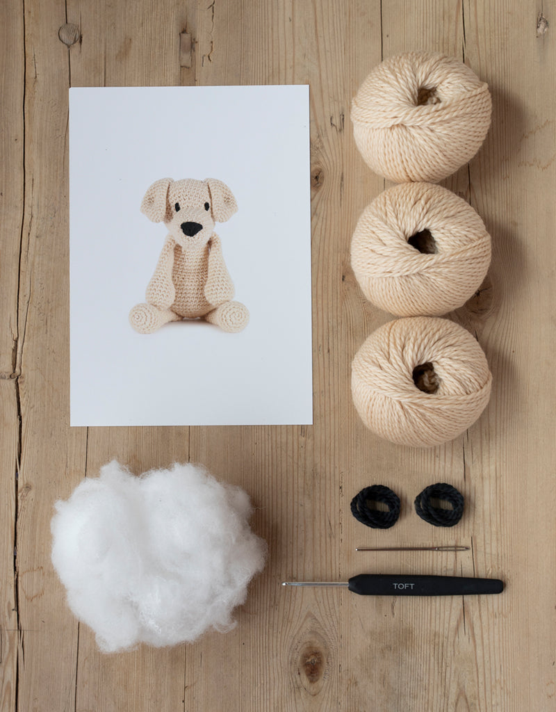 The contents of the kit include yarn, stuffing, needle, and crochet hook