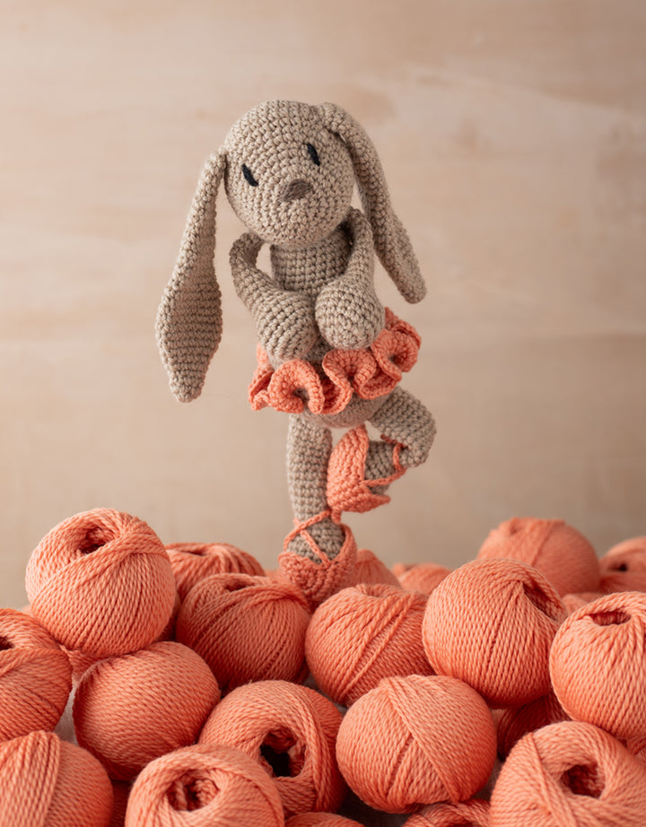 Emma the Ballerina Bunny posed on a pile of yarn balls