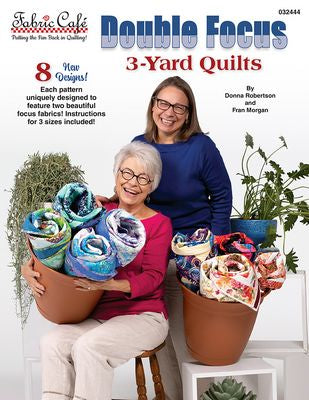Double Focus quilt book with 2 women showing off quilts
