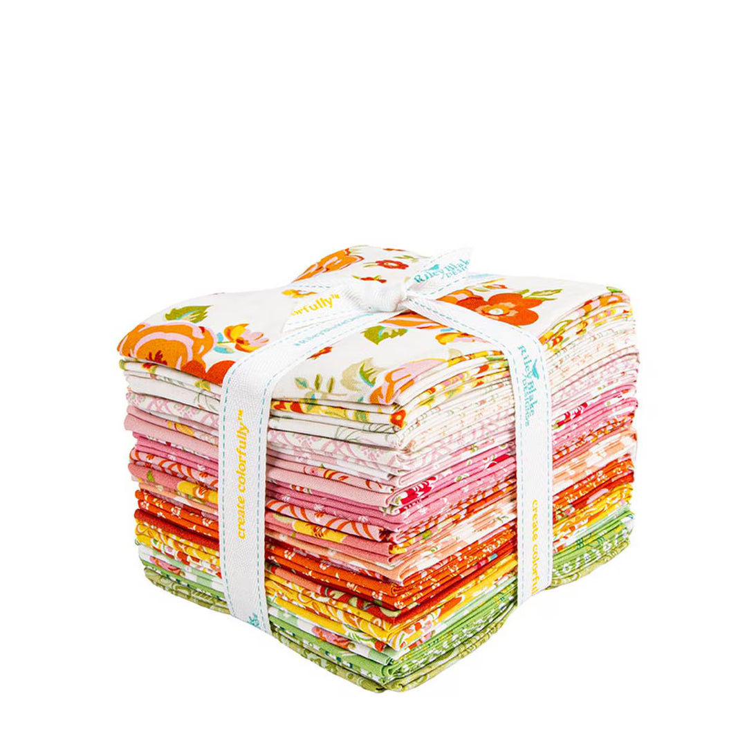 Stack of colorful fabric squares tied with a white ribbon on a white background