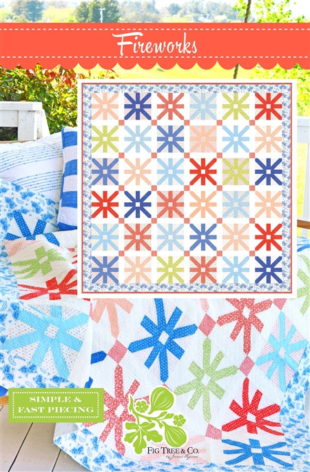 Colorful quilt with star patterns on a wooden surface, featuring the brand 'Fig Tree & Co'.