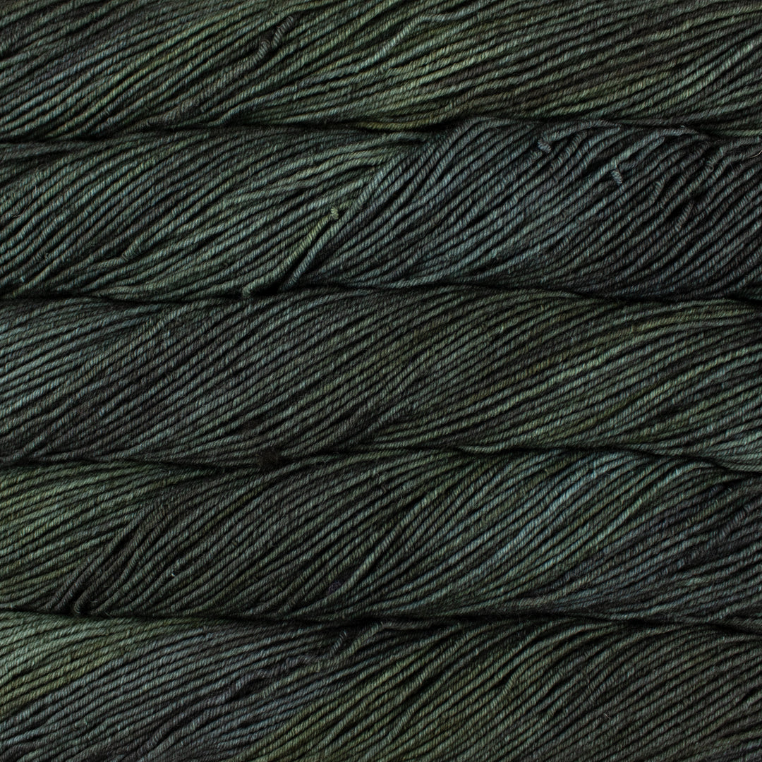 Close-up of dark green yarn with a textured pattern