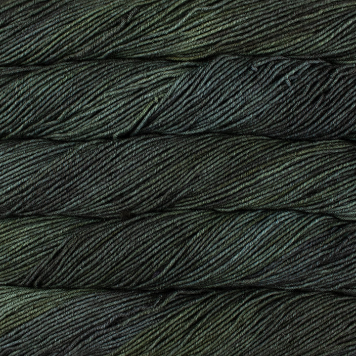 Close-up of dark green yarn with a textured pattern