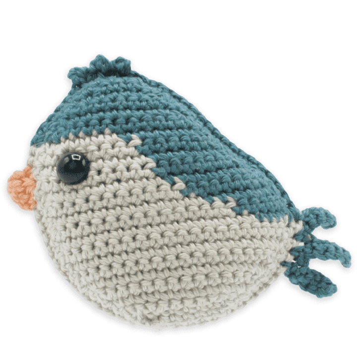 Crocheted bird toy with blue and beige colors on a transparent background