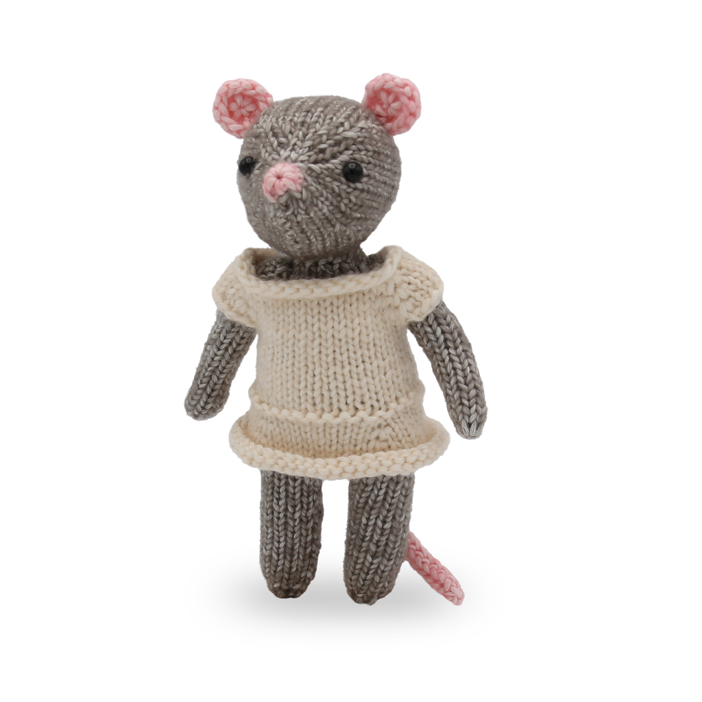 Knitted mouse toy wearing a beige dress on a white background