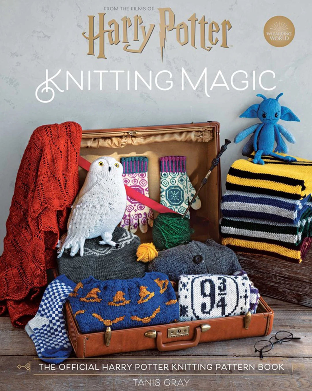 Knitting pattern book cover featuring knitted items and a suitcase with 'Harry Potter' branding.