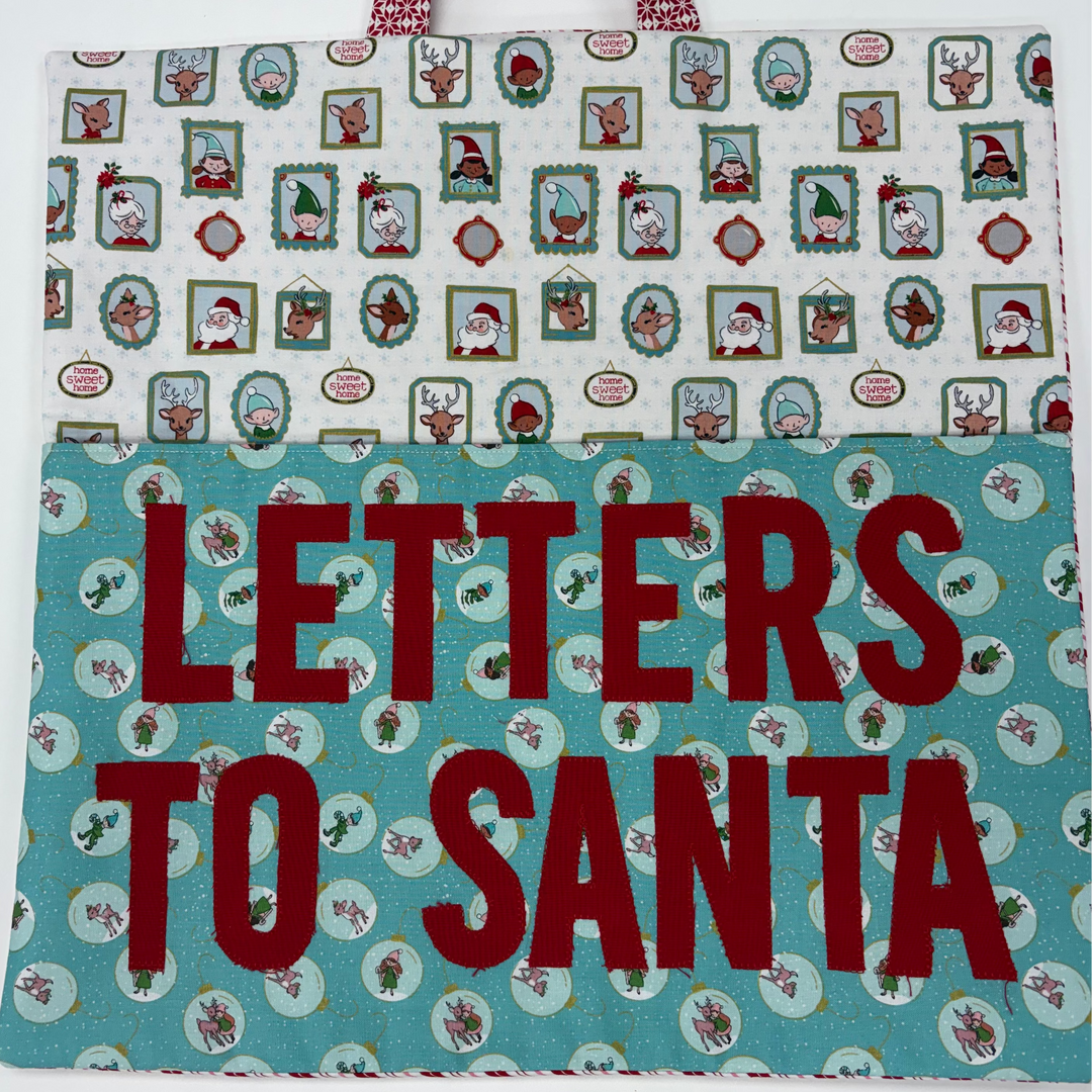 Christmas-themed fabric with 'Letters to Santa' text and festive designs.