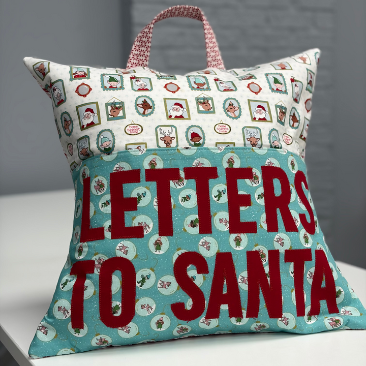 Decorative pillow with 'Letters to Santa' text on a neutral background