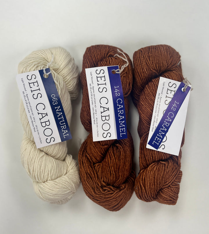 Three skeins of yarn in natural, caramel, and another brown shade with 'SEIS CABOS' labels on a white background.