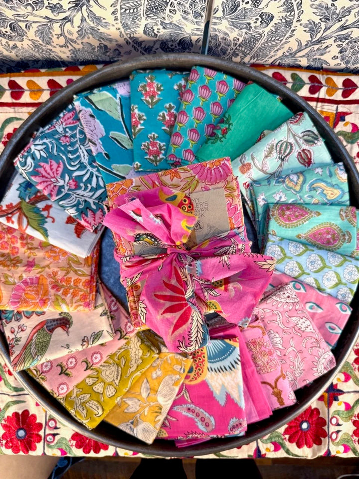 Collection of colorful fabric squares arranged in a circular pattern on a decorative surface.