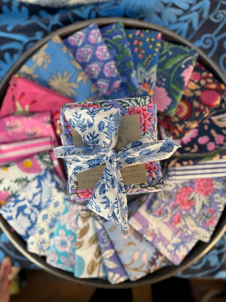 Colorful fabric samples arranged on a circular tray with a floral pattern.