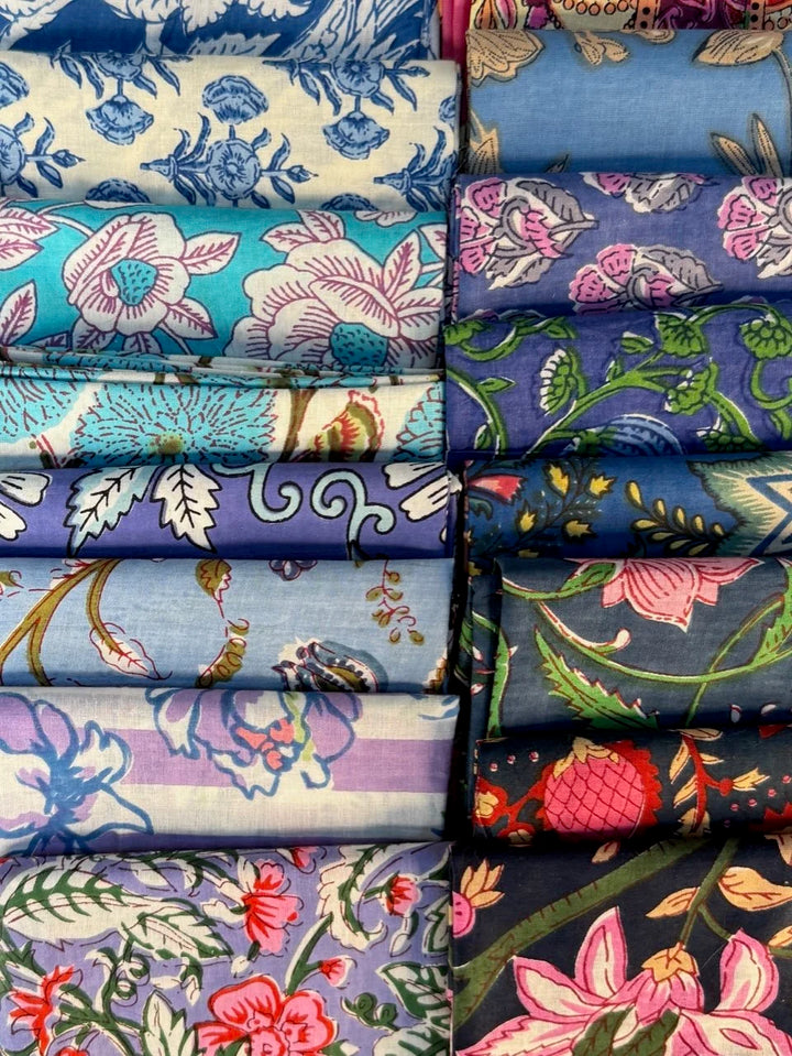 Stack of colorful fabric rolls with floral patterns