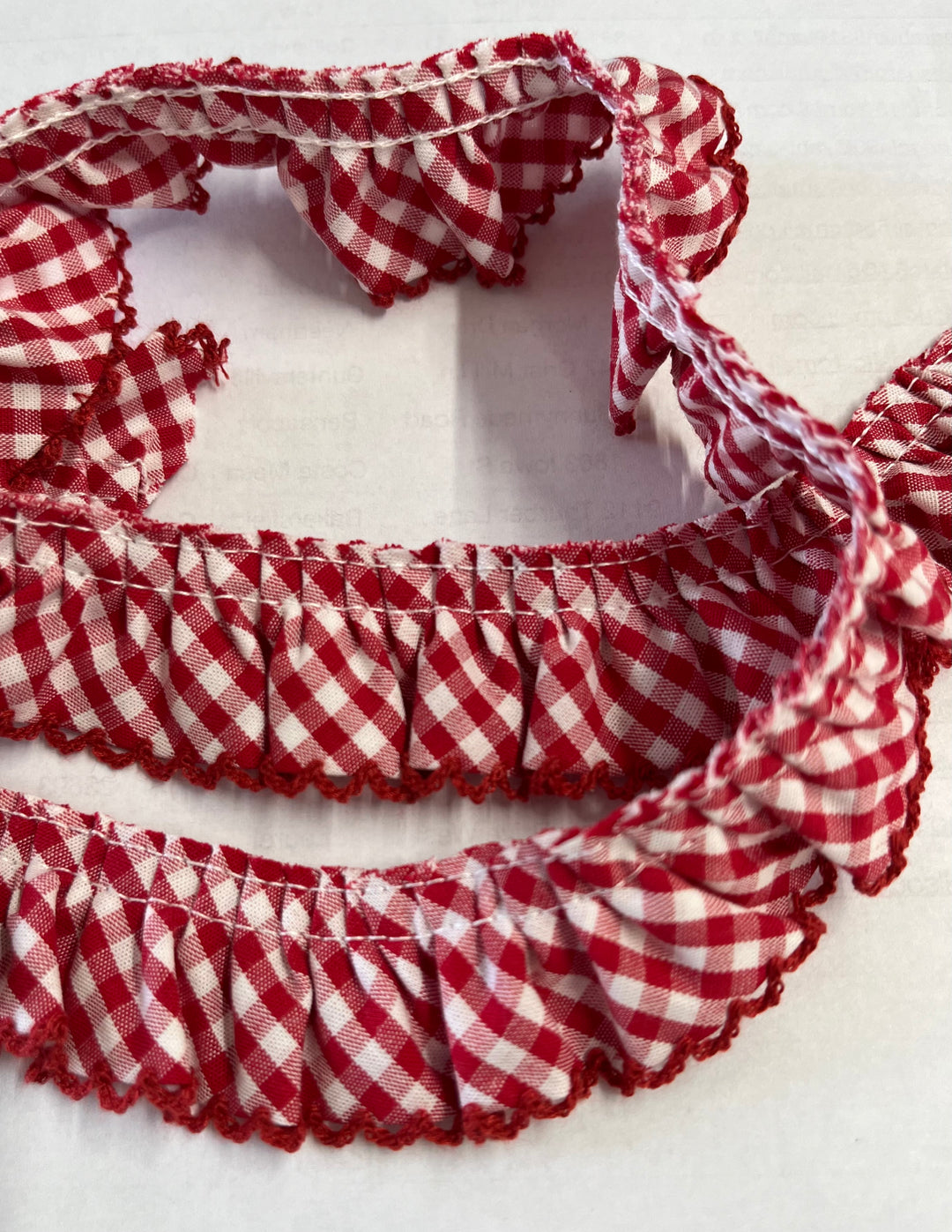 red and white gingham gathered fabric ruffle with a red pico edge