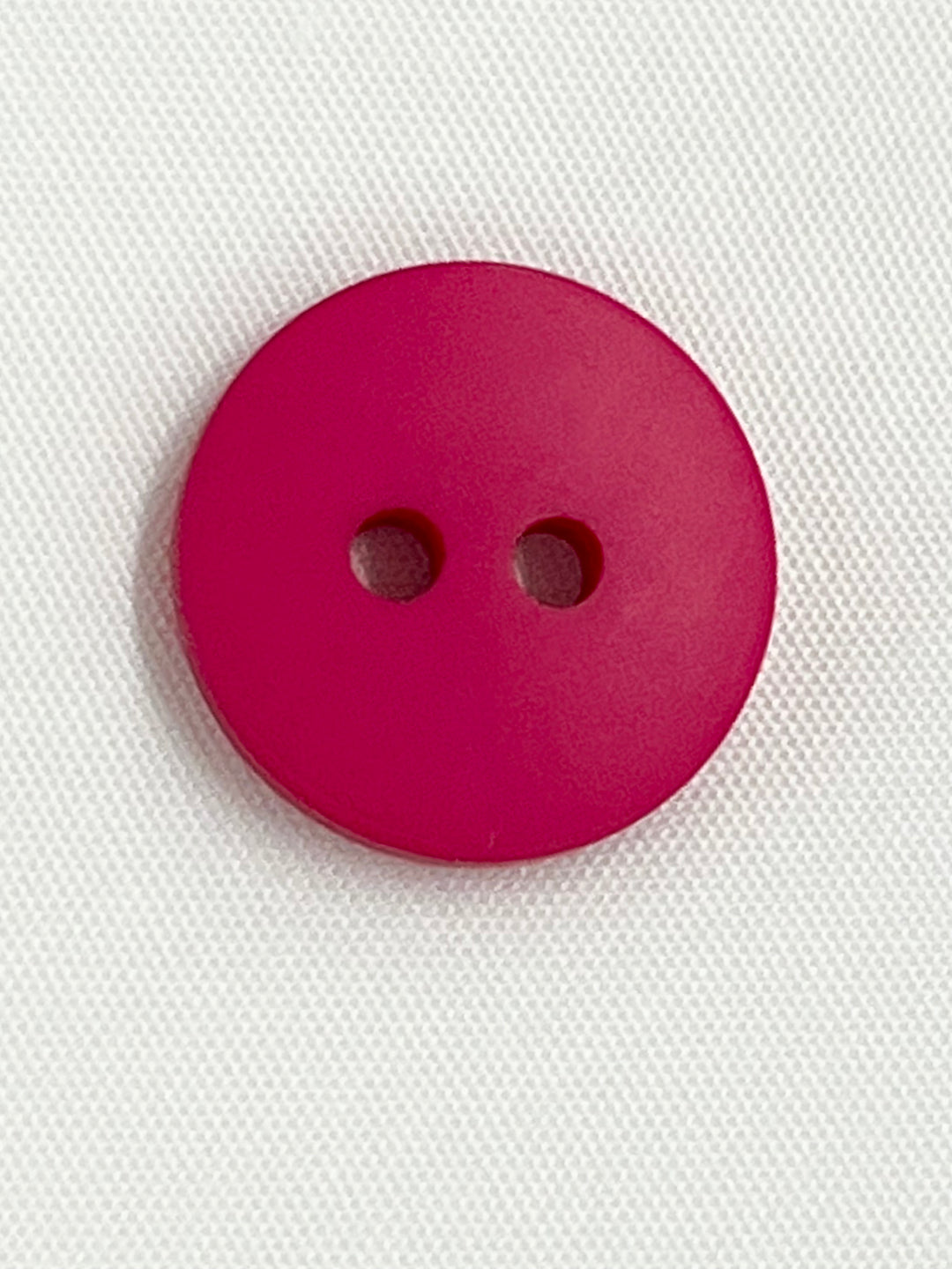 pink 2 hole button on a white background
