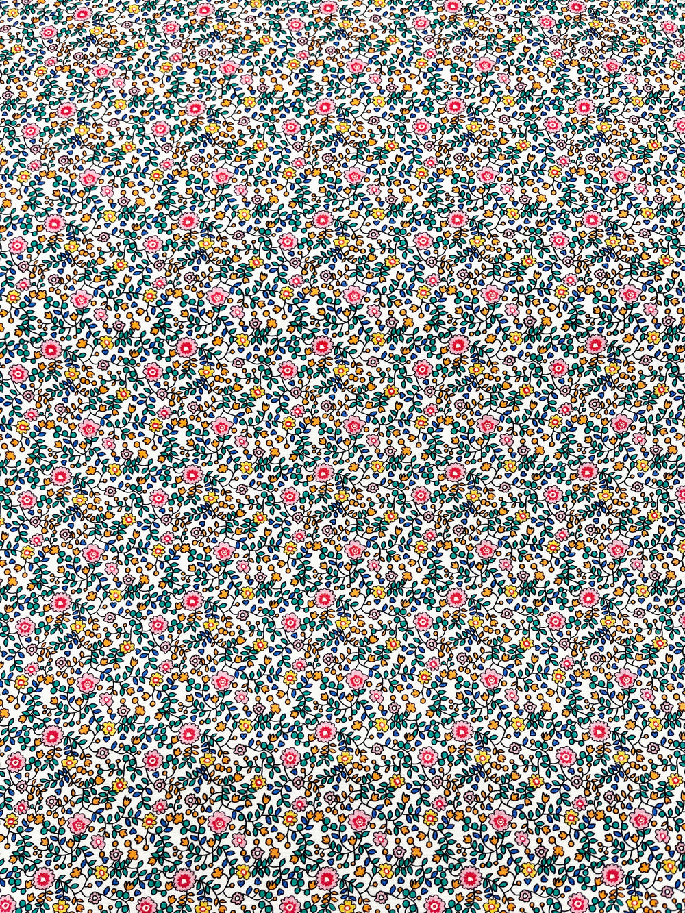 teal, blue, pink, orange and green floral print on a solid white background