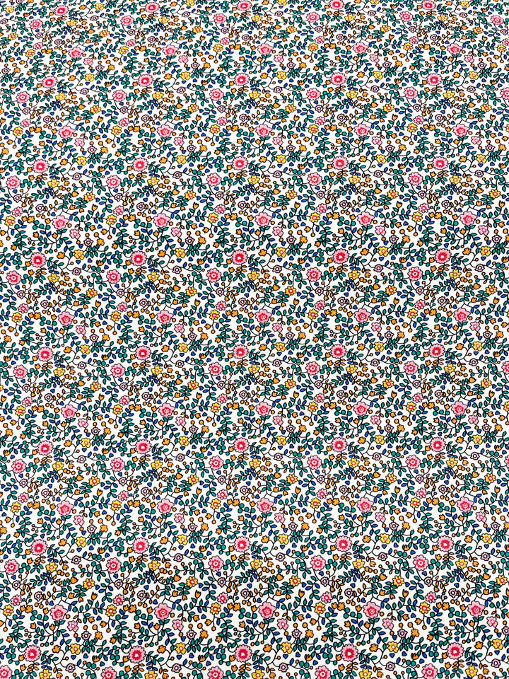 teal, blue, pink, orange and green floral print on a solid white background
