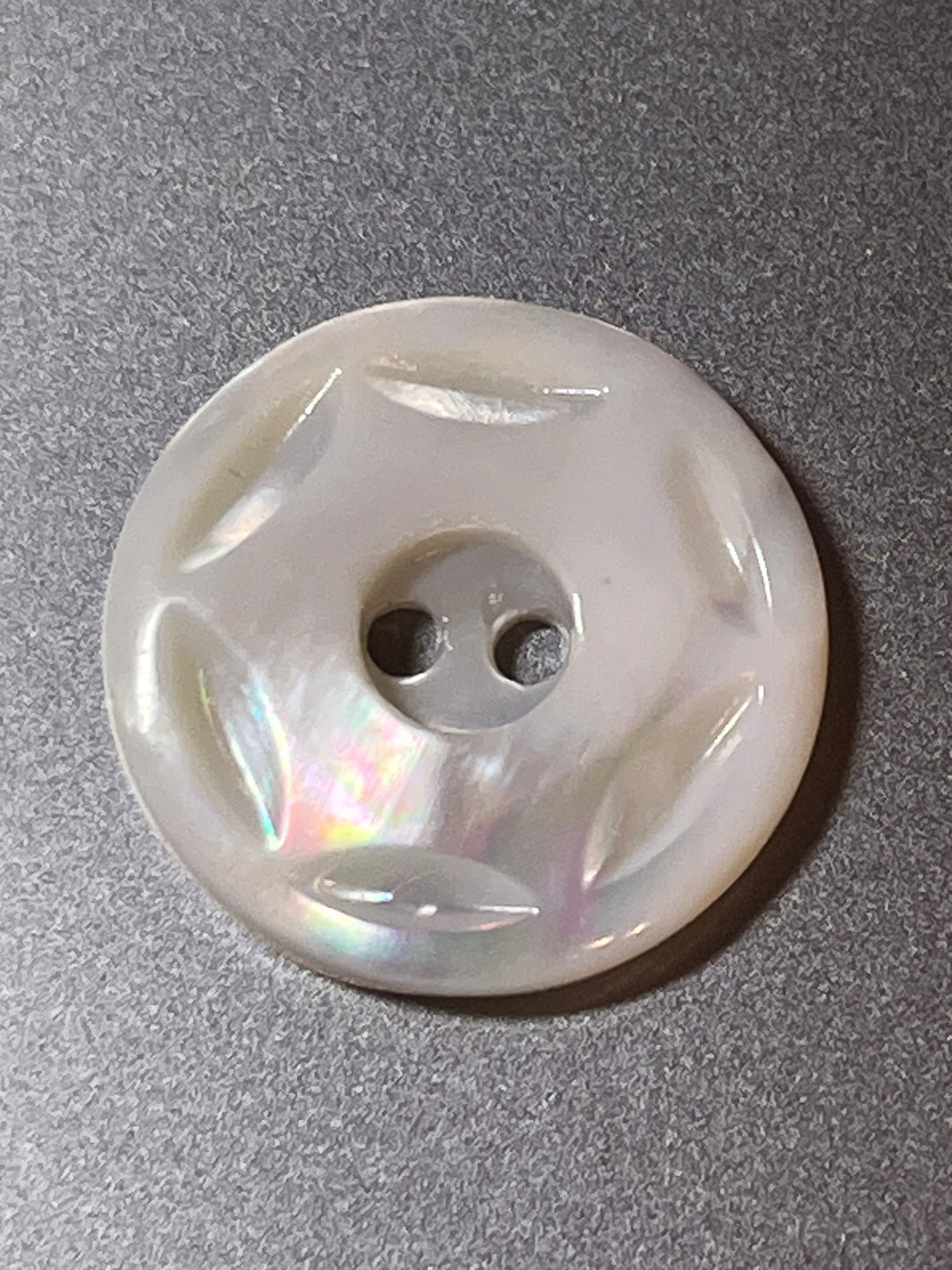 Pearl button on a gray background