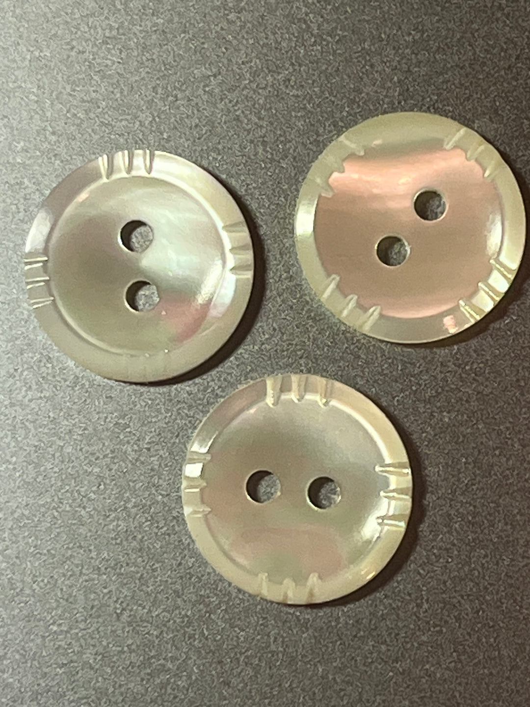 Three round buttons on a gray background