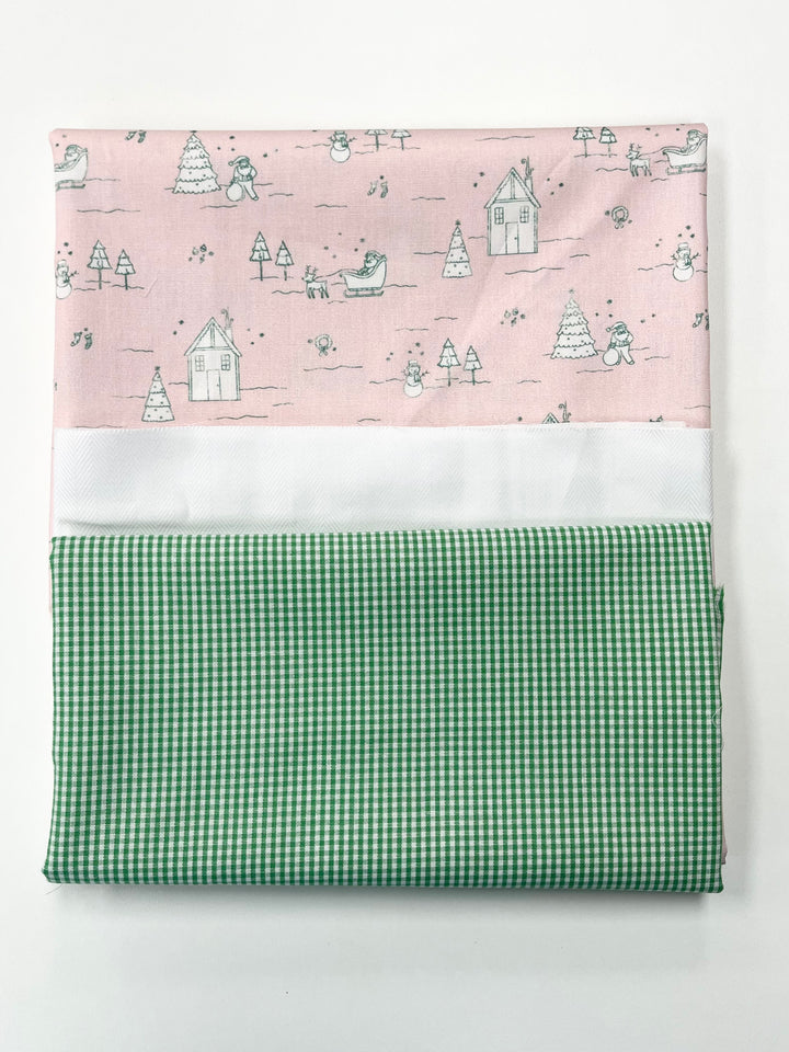 Fabric swatch with pink patterned top and green checkered bottom on a white background