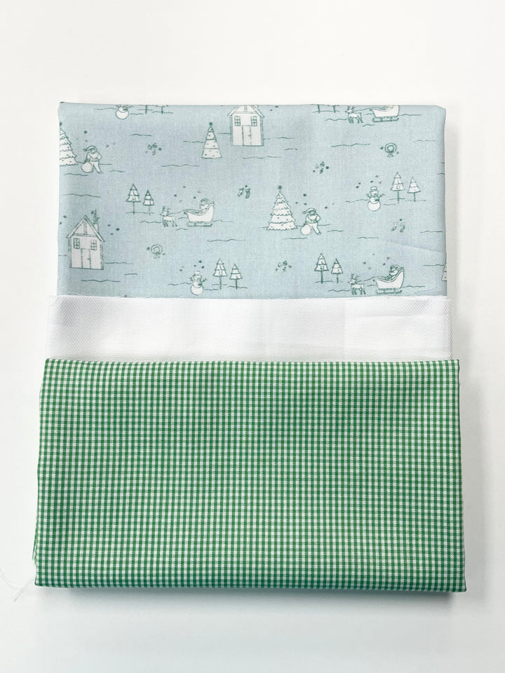 Two fabric swatches, one with a winter scene pattern and the other with a green checkered pattern, on a white background.