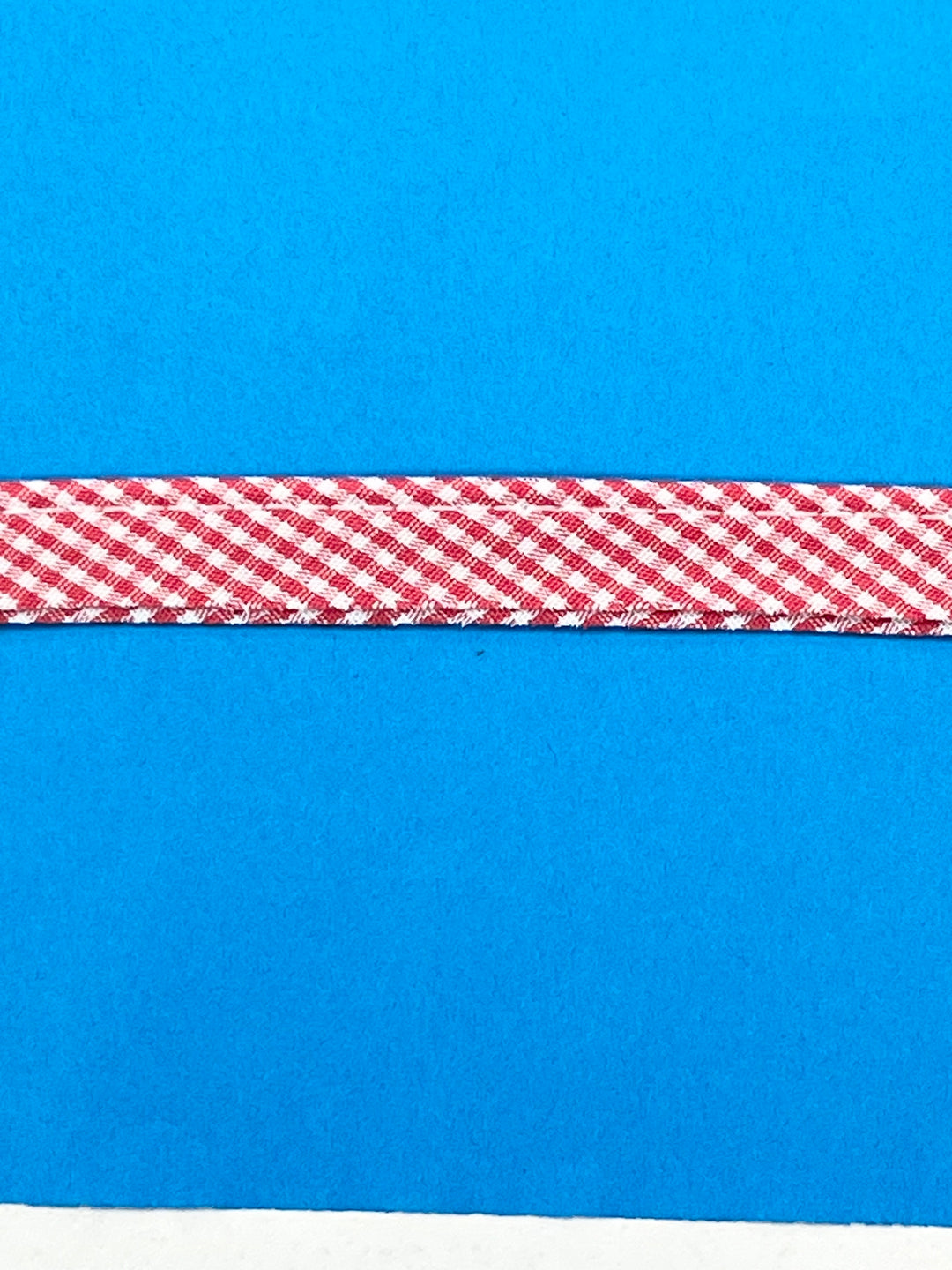Red and white checkered ribbon on a blue background