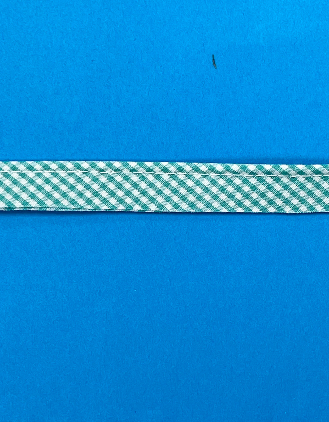 Green and white checkered ribbon on a blue background