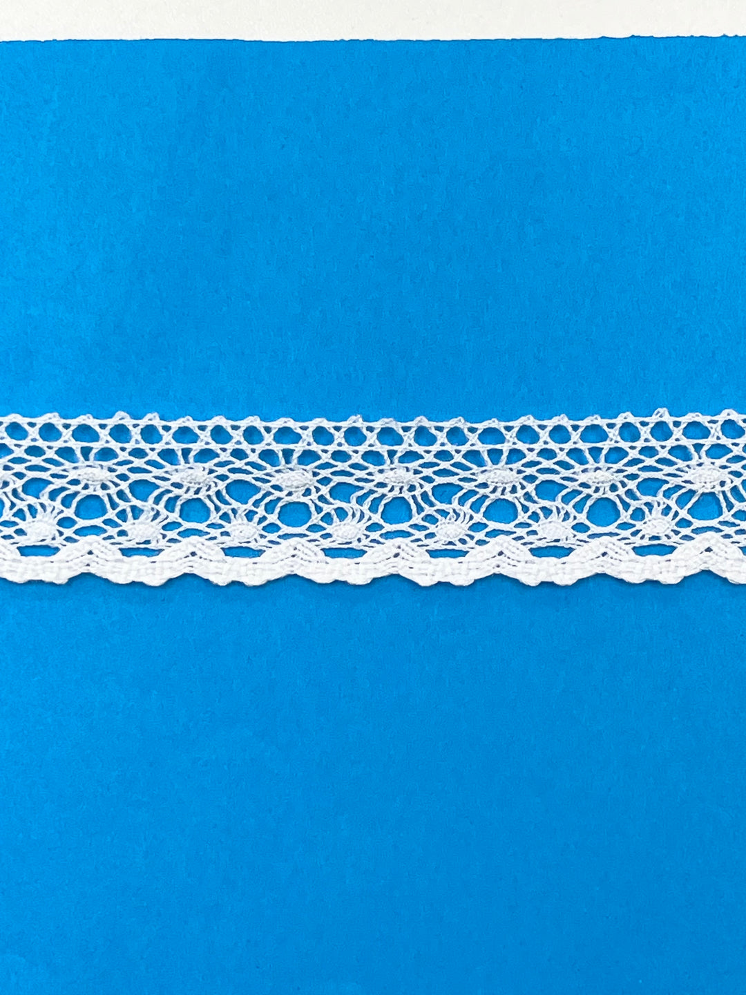 White lace trim on a blue background