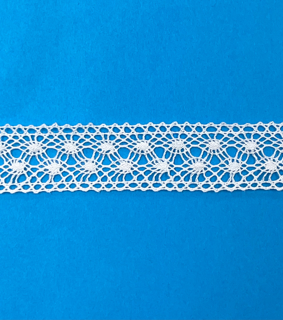 White lace trim on a blue background
