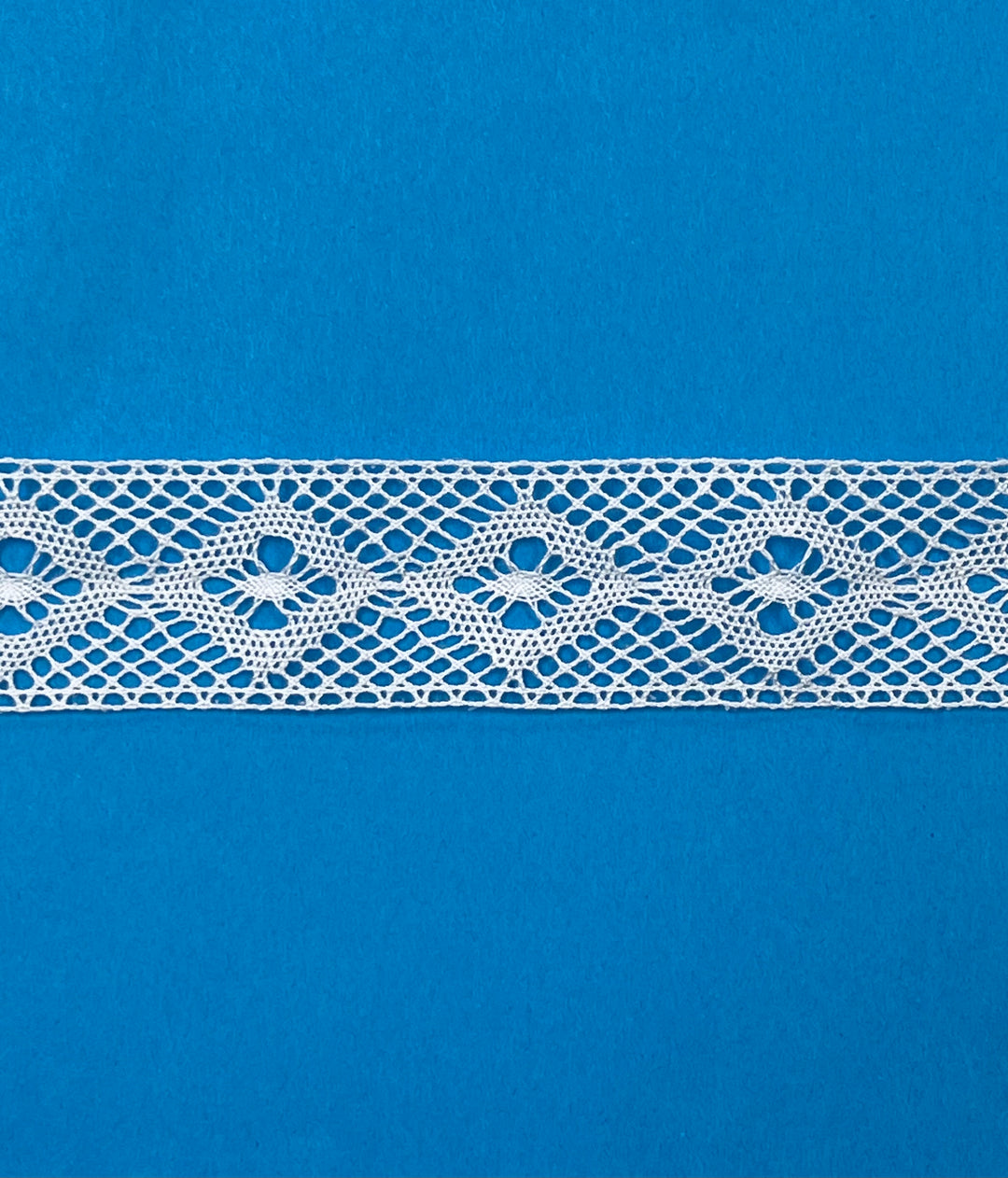 White lace trim on a blue background