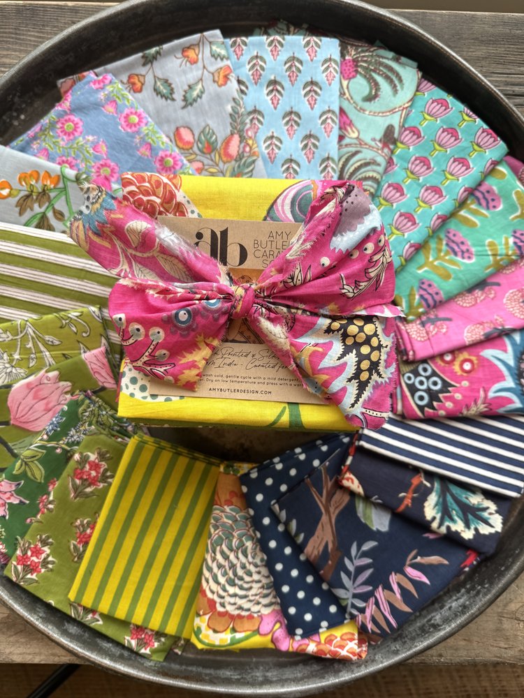 Collection of colorful fabric samples in a metal tray