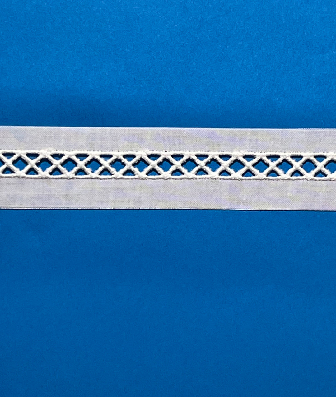 Decorative white lace trim on a blue background