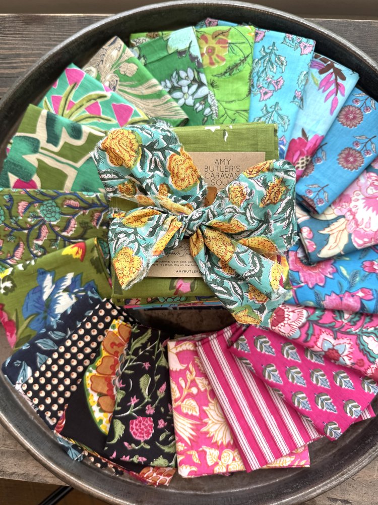 Collection of colorful fabric swatches in a metal tray