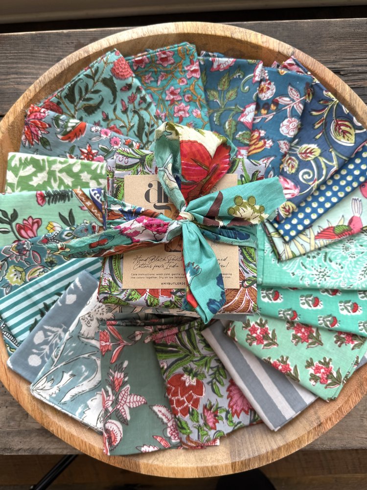 Collection of colorful fabric swatches arranged on a wooden surface