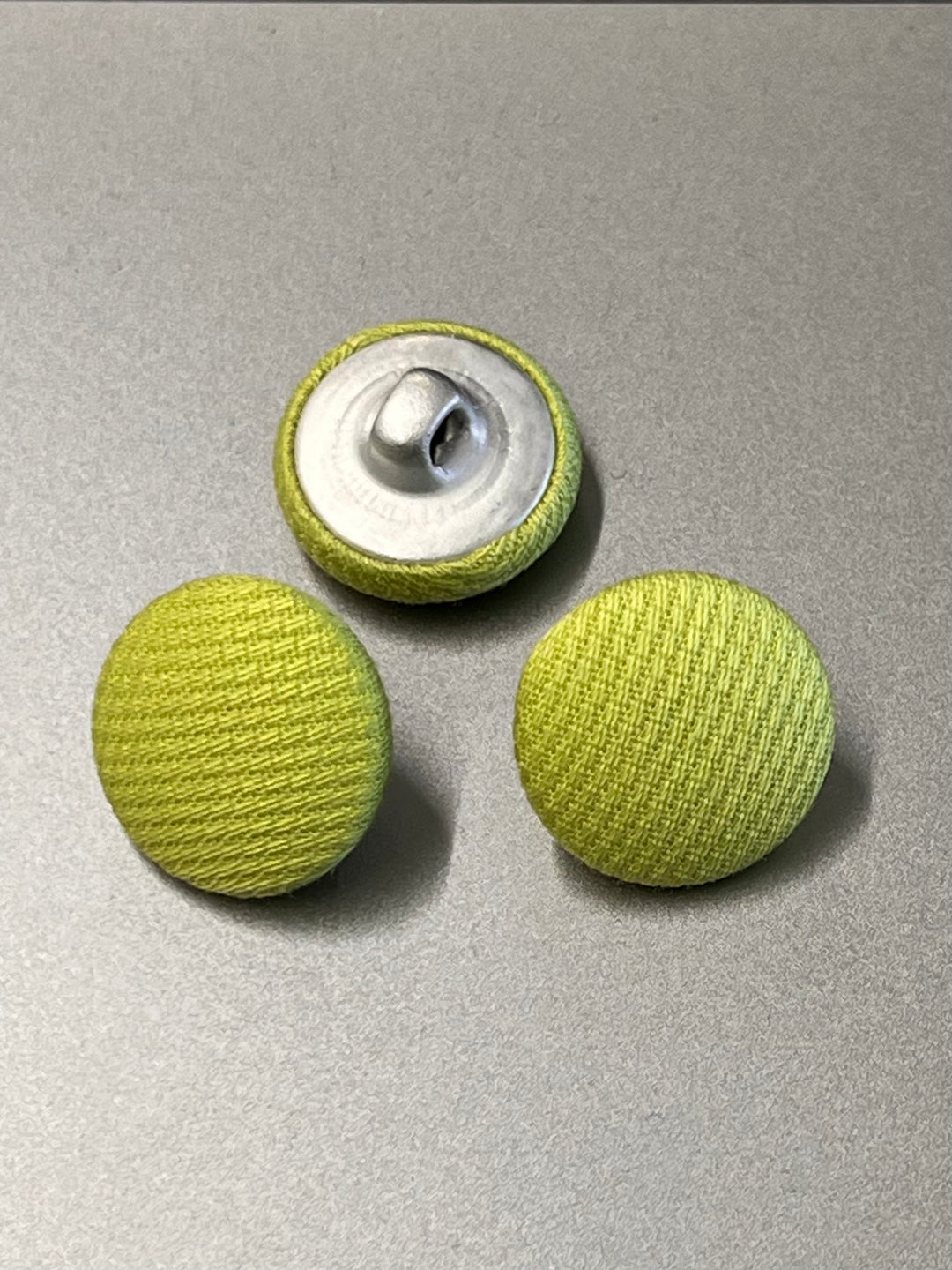lime covered buttons on a gray background
