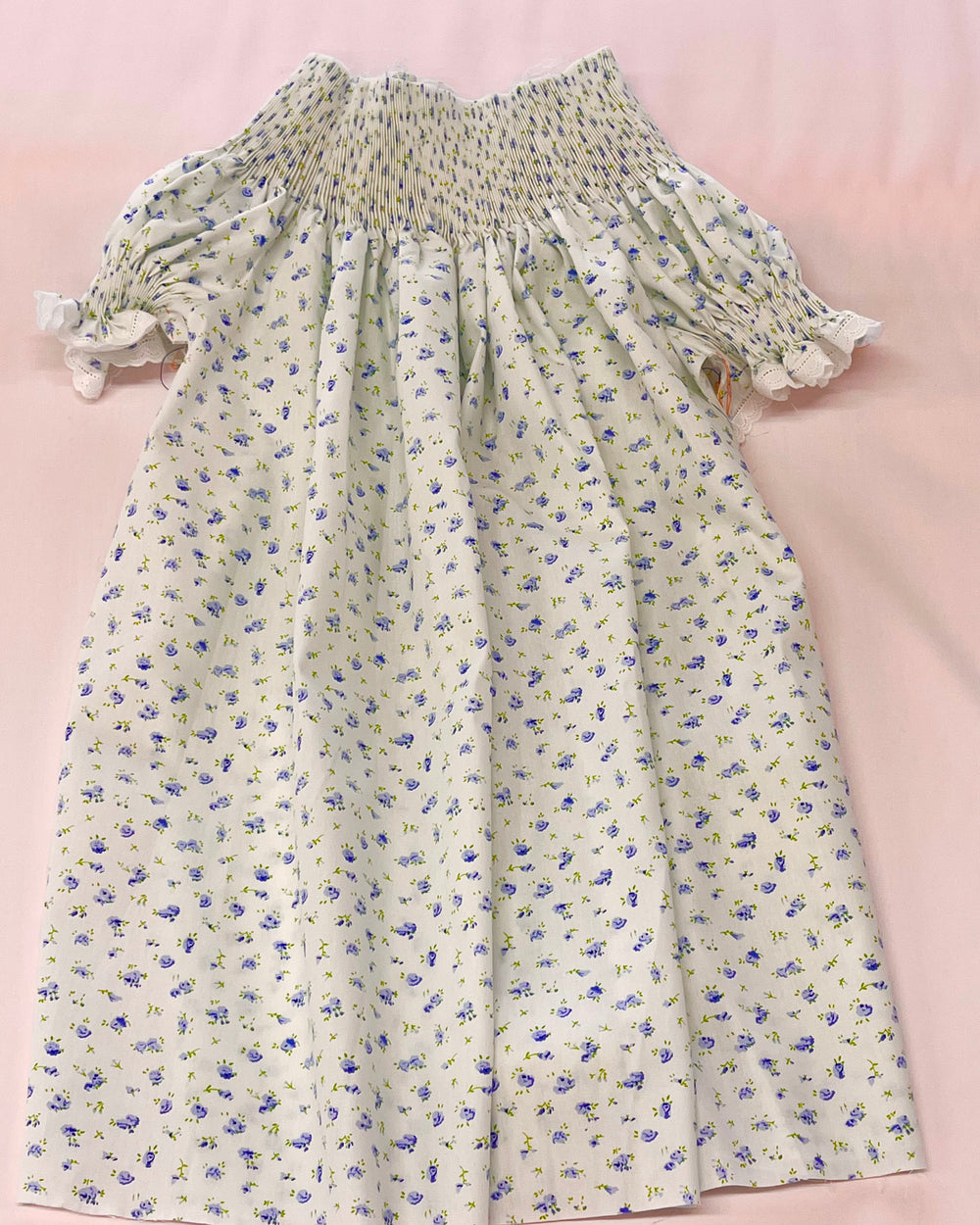 Floral dress with ruffled sleeves on a pink background