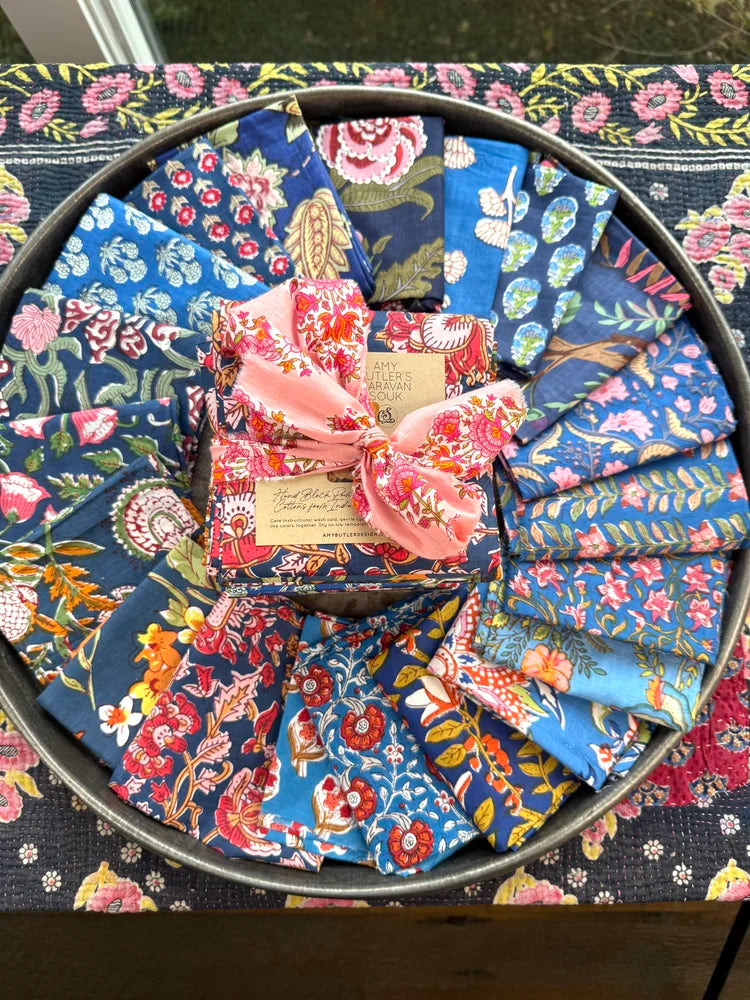 Collection of floral-patterned fabric pieces in a circular arrangement on a matching fabric background.