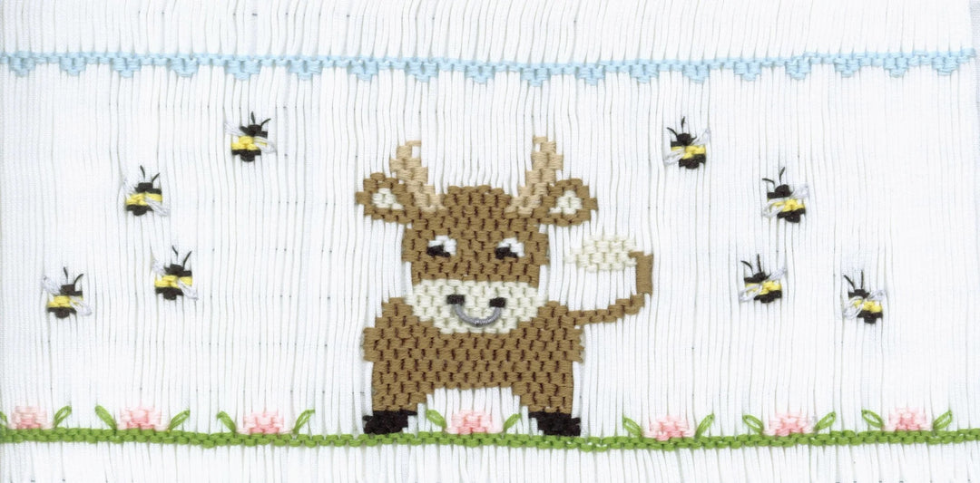 Smocking plate with a bull in a field with bees. 9 rows of smocking on a yoke.