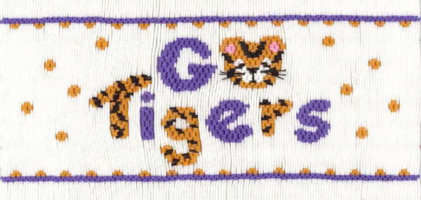 Smocking plate with the words "Go Tigers" A tiger's face is the circle of the "O". 8 1/2 rows of smocking on a yoke.