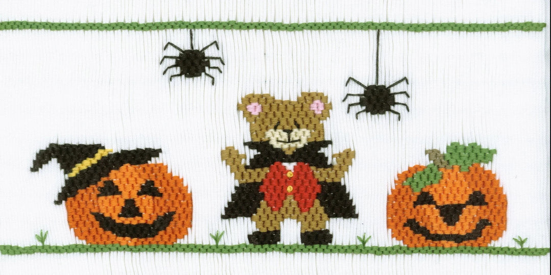 Smocking plate with Halloween bear with jack-o-lanterns and spiders. 9 rows of smocking on a yoke.