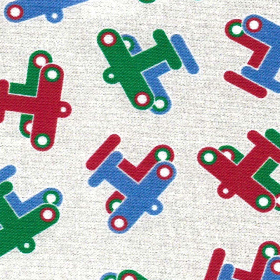 fabric swatch with red, green, and blue planes on a beige background.