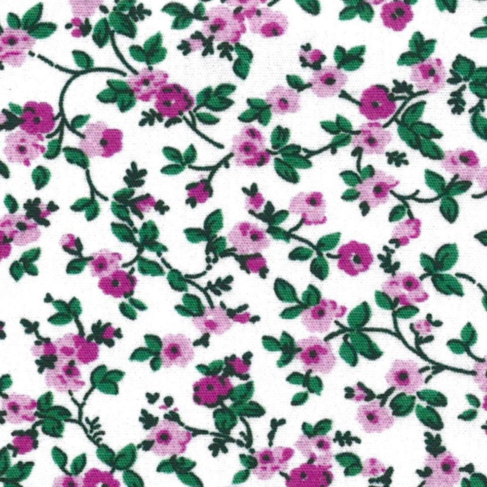 A dense all-over floral print featuring small pink flowers and green leaves on a white background.