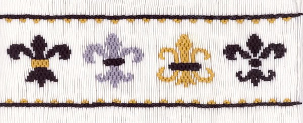 Smocked insert with black, purple, and gold fleur-de-lis patterns on a white background.