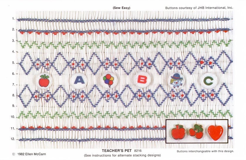 Embroidery pattern with letters and symbols on fabric, featuring buttons from JHB International.