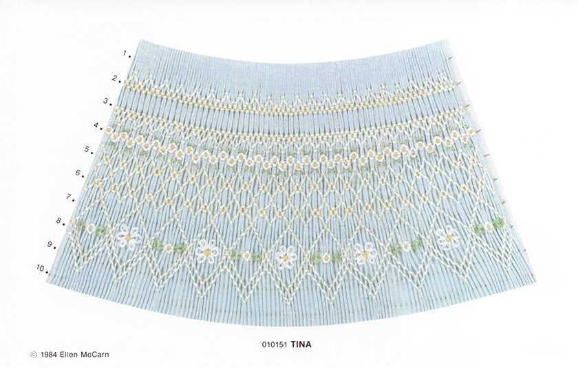 Light blue pleated fabric with white floral embroidery on a white background