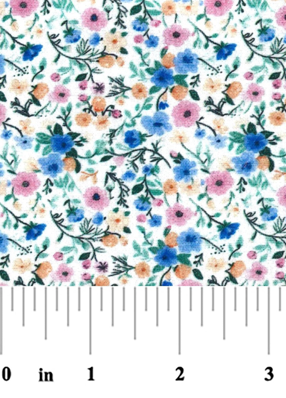 A close-up of a white fabric with a dense, repeating floral pattern featuring blue, pink, orange, and green flowers and leaves with a ruler at the bottom for scale.