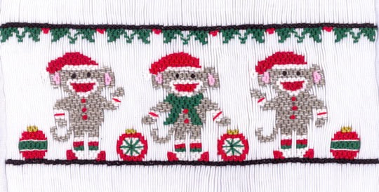 Smocking plate with three sock monkeys in their Christmas best and presents. 8 1/2 rows of smocking on a yoke.